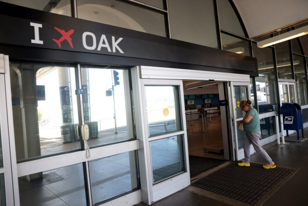 The "I Fly OAK" logo is seen as a passenger enters Oakland San Francisco Bay Airport's Terminal 1 in Oakland, Calif., on Tuesday, April 28, 2026. Officials announced today that a long-running dispute over the name of Oakland's airport has been resolved. (Jane Tyska/Bay Area News Group)