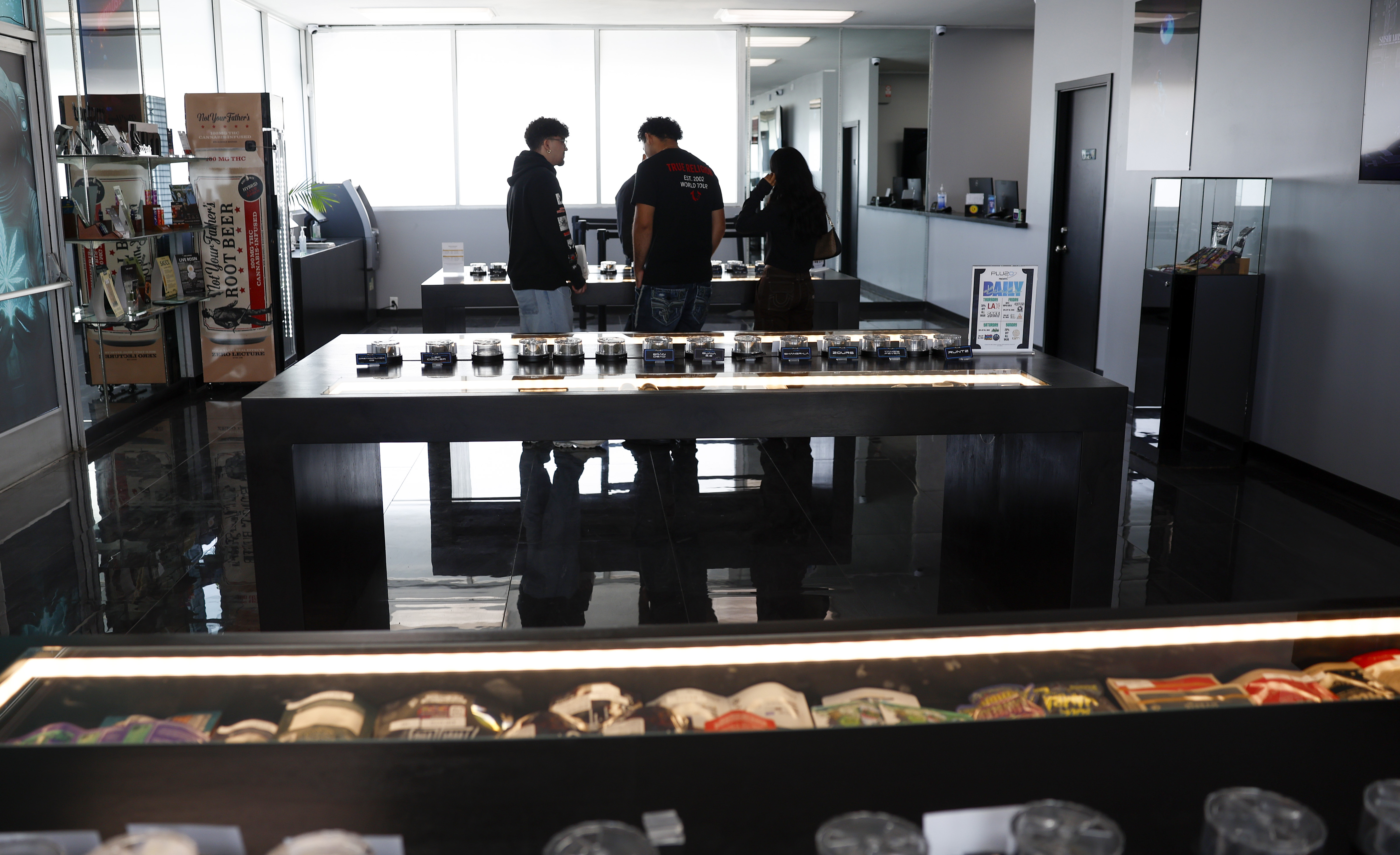 Customers shop at Plu2O Dispensary in San Jose, Calif., on...