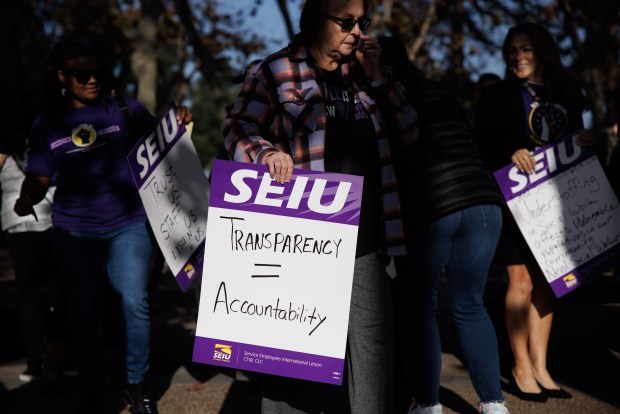 Santa Clara County social workers, including supervisor Michelle Dove, carry signs on their way to a Dec. 5 Board of Supervisors meeting where they demanded accountability over the death of baby Phoenix Castro. (Dai Sugano/Bay Area News Group)