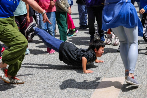 Rooftop Elementary School third graders take part in a dance led by One Dance instructors during the Bay Area Dance Week kickoff event at Jesse Square in San Francisco, Friday, April 24, 2026. Bay Area Dance Week is a 10-day celebration of various dance styles held throughout the Bay Area. The One Dance performance included a Soul Line Dance class led by Oakland's Chocolate Platinum. (Ray Chavez/Bay Area News Group)