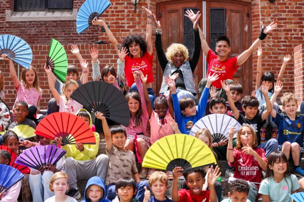 Rooftop Elementary School third graders gather for a group photo with One Dance instructors Amy Rose, top left, and artistic director Dudley Flores, right, and Soul Line Dance instructor Chocolate Platinum of Oakland, top middle, after dancing during the Bay Area Dance Week kickoff event at Jesse Square in San Francisco, Friday, April 24, 2026. Bay Area Dance Week is a 10-day celebration of various dance styles held throughout the Bay Area. The One Dance performance included a 30-minute Soul Line Dance class led by Platinum. (Ray Chavez/Bay Area News Group)