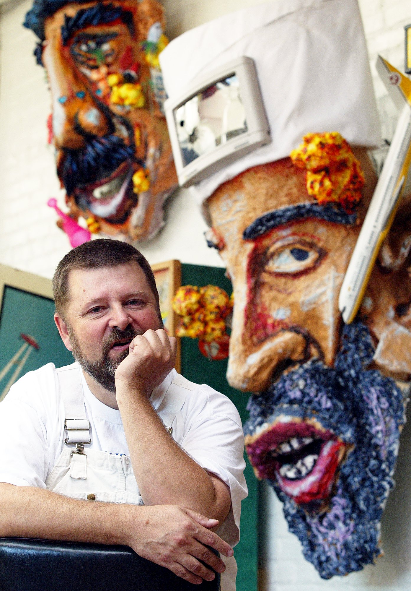 Oakland artist Dan Fontes poses with two of his pieces...