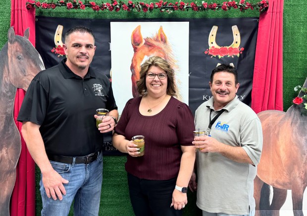 Fair Downs Director of Operations Armando Carlos, left, Santa Clara County Fairgrounds Executive Director Salene Duarte, center, and Daryle Lupretta, the fairgrounds' food and beverage director, pose in front of a display for the Kentucky Derby party at the Fair Downs off-track-betting facility at the Santa Clara County Fairgrounds on Saturday, May 2, 2026. (Sal Pizarro/Bay Area News Group)