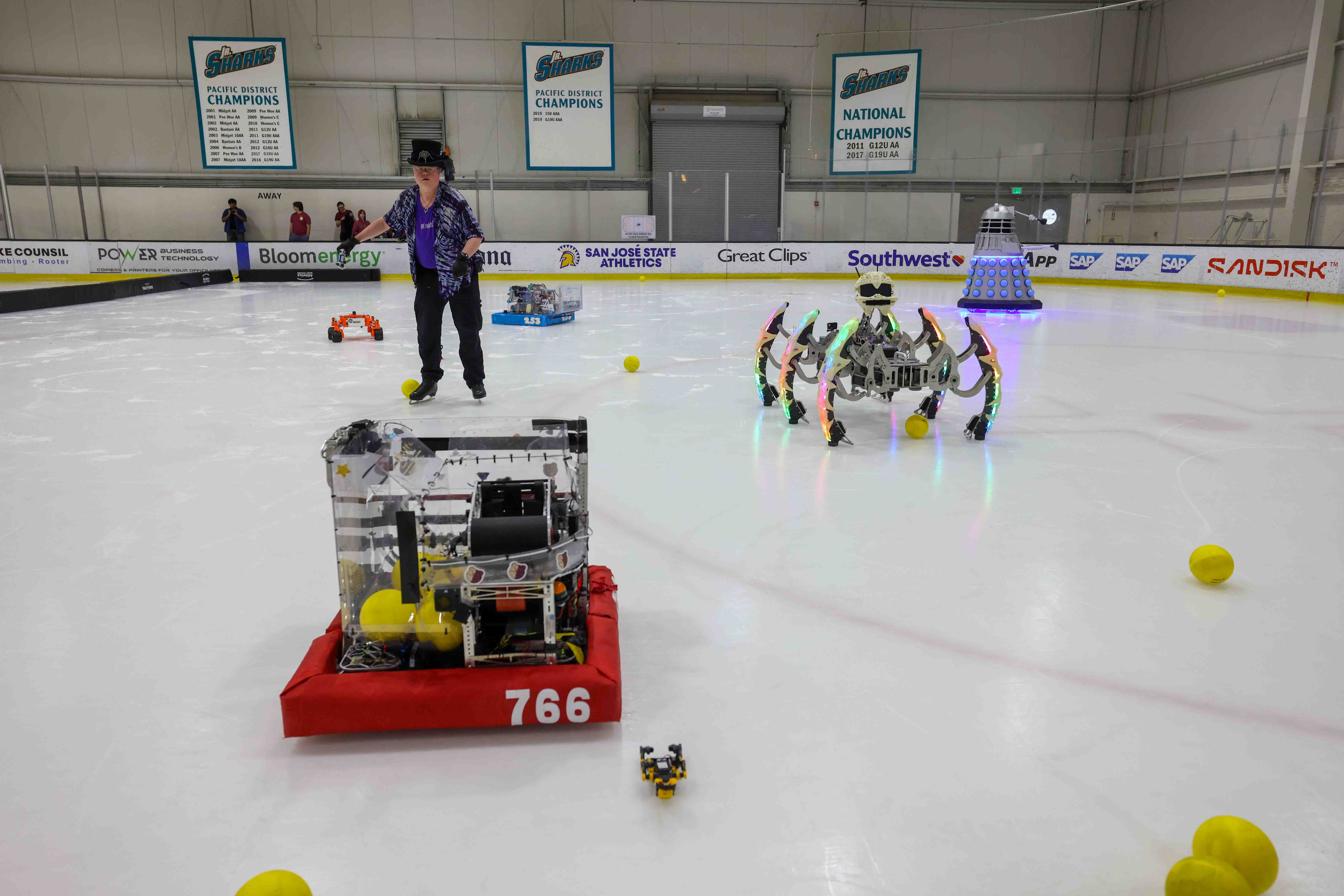 Nick Donaldson skates after checking his robot, Marauder, middle, during...