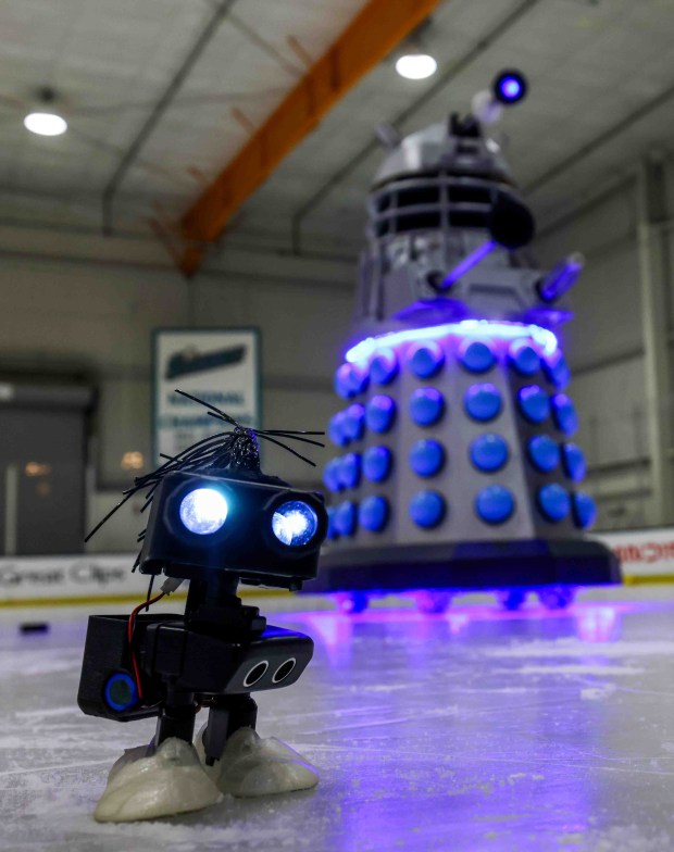 A small robot passes Dalekand, a replica robot from the Doctor Who show, during the Robots on Ice event at Sharks Ice San Jose in San Jose, Calif., on Saturday, April 24, 2026. (Ray Chavez/Bay Area News Group)