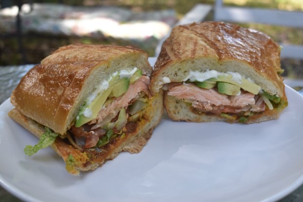 At Bonne Sante in Burlingame, giant, gorgeous and affordable sandwiches are the norm, like the Wild Alaskan, a sandwich filled with avocado, grilled salmon, mayonnaise, mustard, lettuce, tomato, pickle, onion and the deli's signature sun-dried tomato tapenade.​ (Kate Bradshaw/Bay Area News Group)
