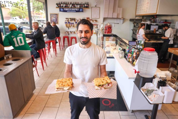 Co-owner Antonio Merolla shows a Porchetta Italian sandwich, left, and a Pistacchio Italian sandwich on focaccia bread at Gusto Mio in Walnut Creek, Calif., Friday, April 10, 2026. (Ray Chavez/Bay Area News Group)