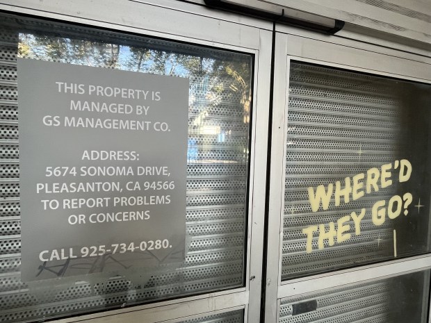 Entry area of 27 South First St., a commercial building in downtown San Jose, seen on April 2, 2026. Contact information for a property management firm and a metal barrier inside the door are visible.(George Avalos/Bay Area News Group)