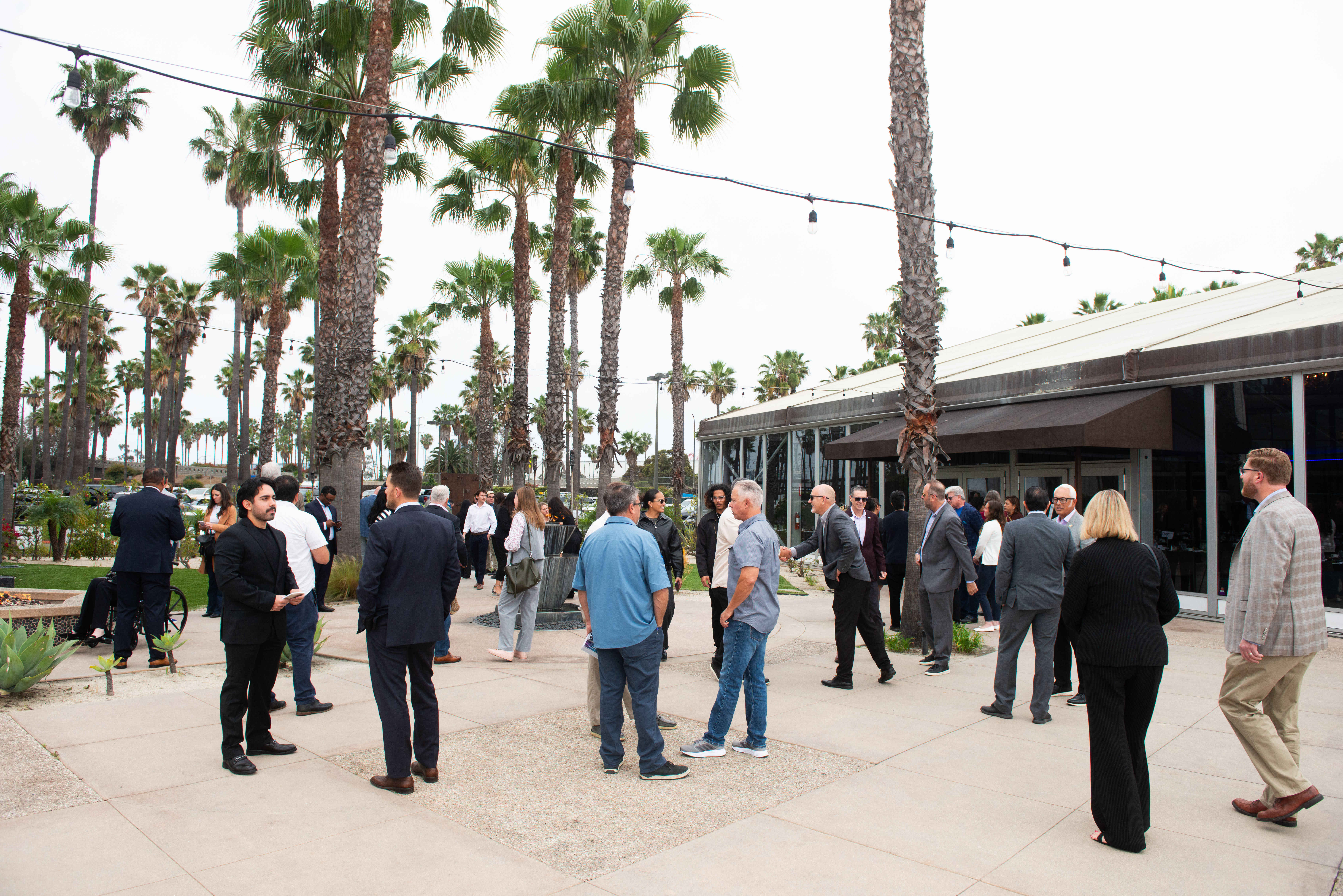 Attendees of the fourth annual Space Beach Luncheon gather before...
