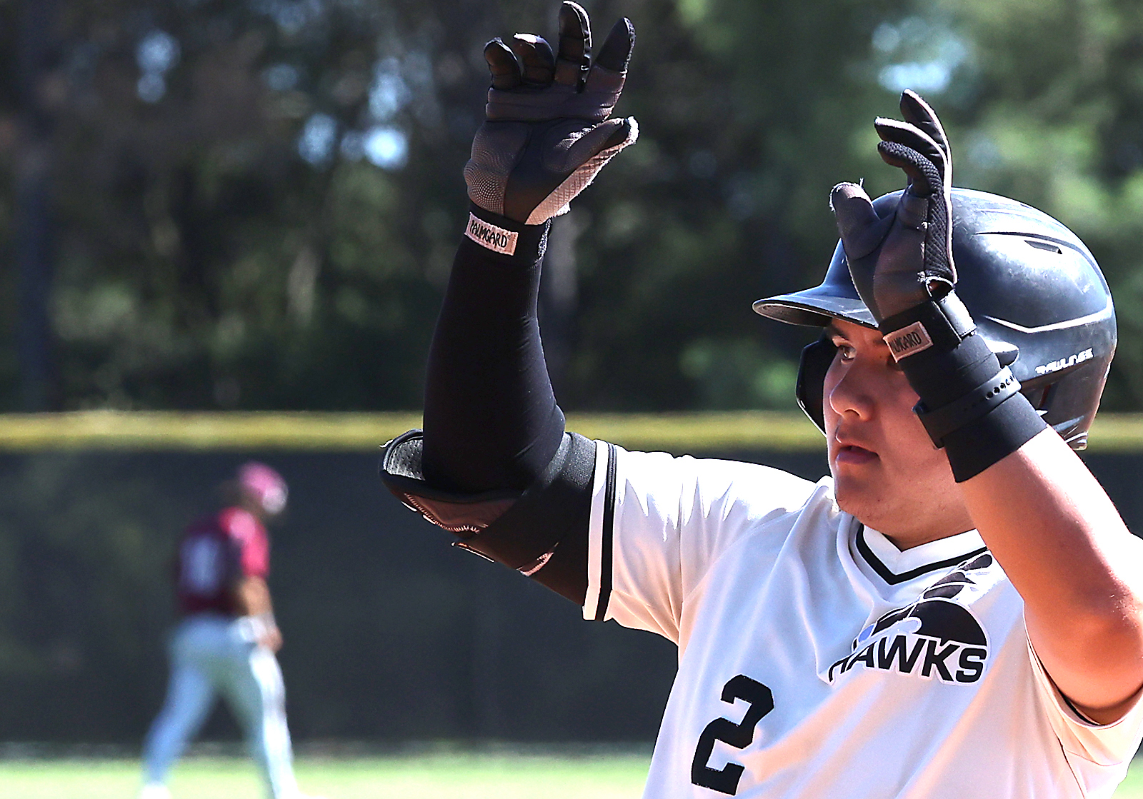 Cabrillo Collegeâs Trez Uemoto gestures to the dugout after hitting...