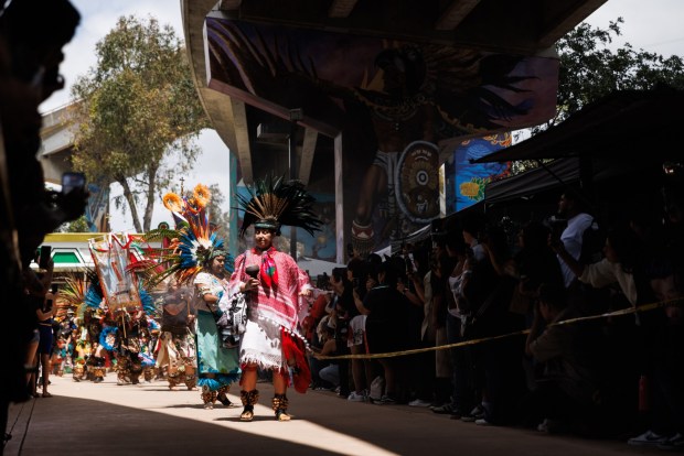 Aztec dancers from multiple danza Azteca groups perform for a blessing during Chicano Park Day, the 56th anniversary of the park, in Barrio Logan on Saturday, April 25, 2026. The day celebrates the community's opposition to the construction of a police station in 1970. (Kristian Carreon / The San Diego Union-Tribune)