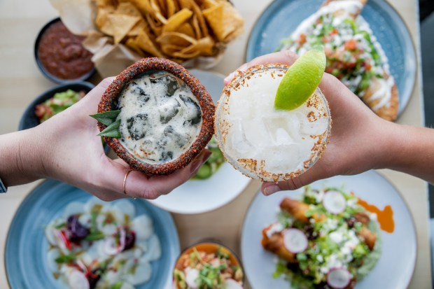 Coasterra's happy hour menu mixes signature cocktails and appetizers such as ceviche, guacamole, and chips, calamari and chicken tinga tostadas.(Cohn Restaurant Group)