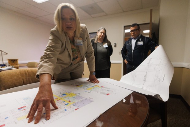 Michelle Ziemba, chief operating officer at UCSD East Campus Medical Center, goes through blueprints of the hospital, formerly Alvarado Medical Center, on Friday, April, 3 2026. (Kristian Carreon / The San Diego Union-Tribune)