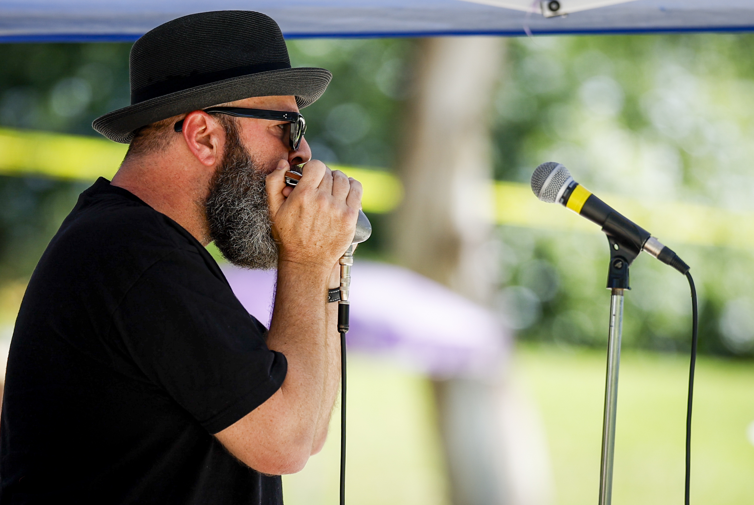 Troy Sandow plays the harmonica during the Spring Harp Fest....