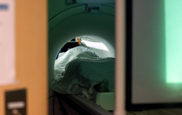 Viewed through a briefly opened door, an Adolesdcent Adolescent Brain Cognitive Development Study participant undergoes a functional magnetic resonance imaging scan on Friday, April 17, 2026, at UC San Diego. (Hayne Palmour IV / For The San Diego Union-Tribune)