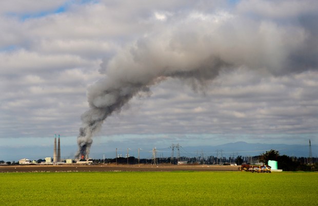 Smoke and flames are seen from Castroville as a fire at the Vistra battery storage plant burns in Moss Landing, Calif., on Friday, Jan. 17, 2025. (Doug Duran/Bay Area News Group)