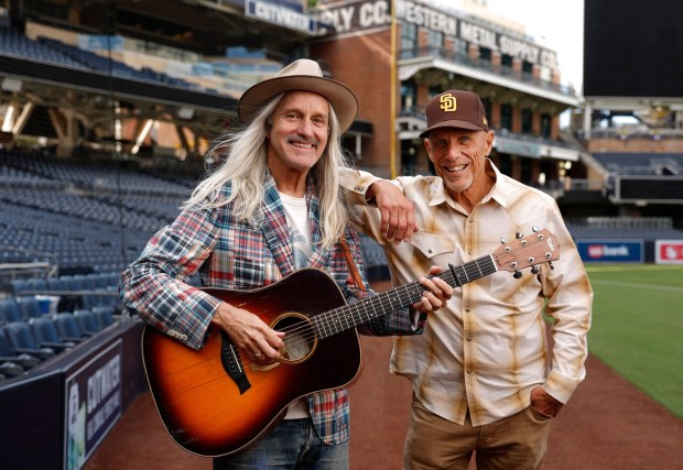 Singer-songwriter Steve Poltz, left, will receive his 2026 San Diego Music Awards Country Dick Montana Lifetime Achievement Award from former San Diego Padres player Tim Flannery. (K.C. Alfred / The San Diego Union-Tribune)