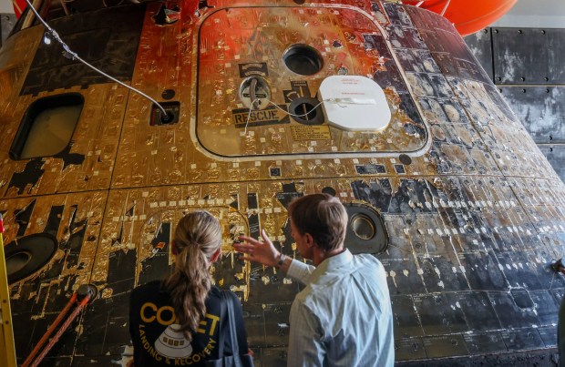 NASA analysts look over the The Artemis II Orion Capsule aboard the USS John P. Murtha at Naval Base San Diego on Saturday, April 11, 2026. The 10-day mission culminated in a successful splashdown off the coast of San Diego. (Sandy Huffaker / For The San Diego Union-Tribune)
