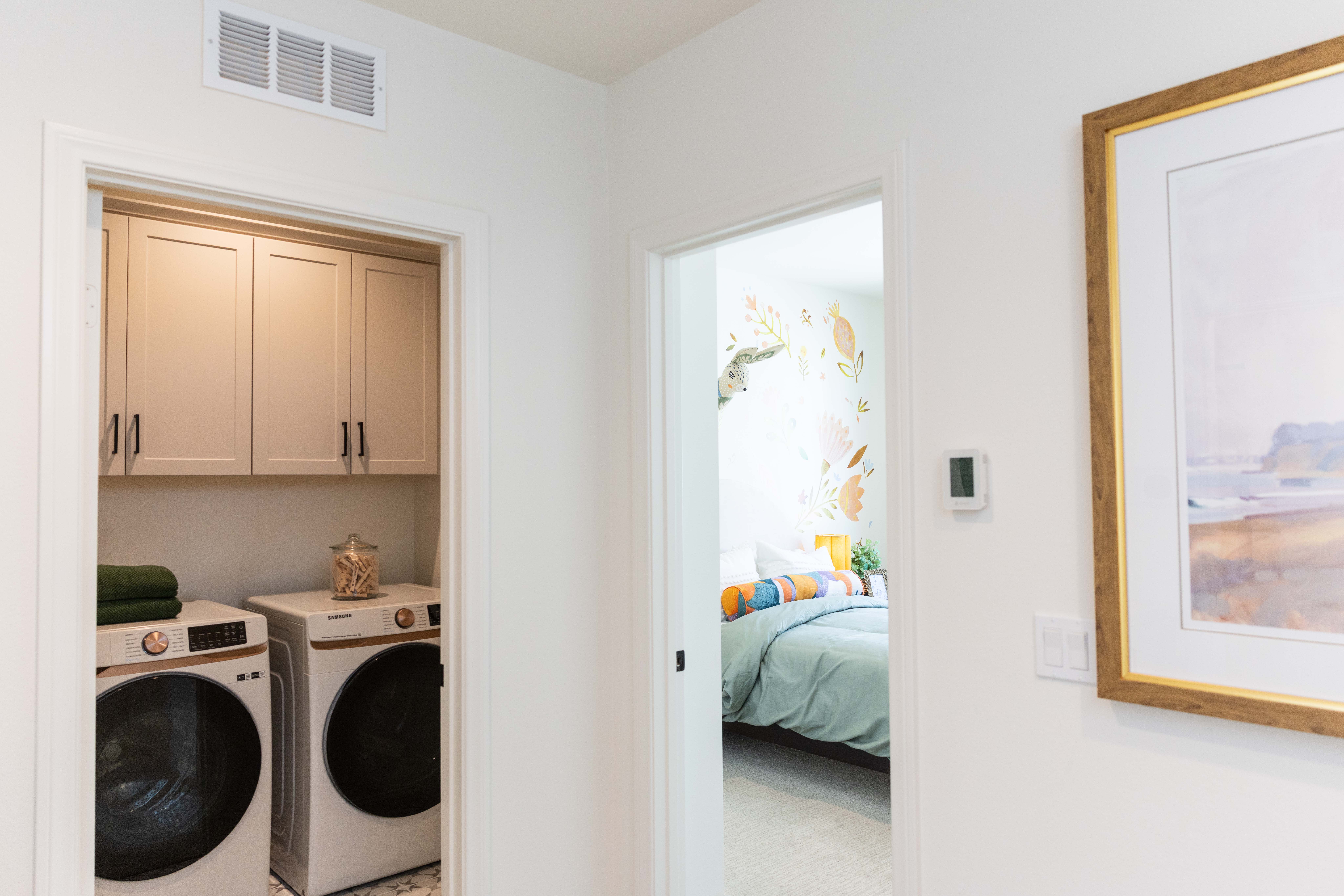 A bedroom and laundry area in a new home in...