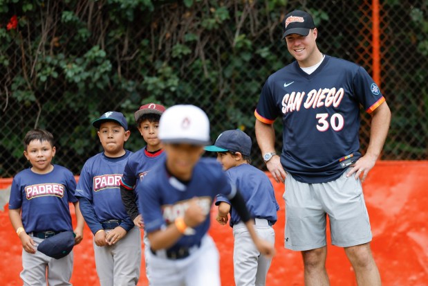 Gavin Sheets #30 of the San Diego Padres smiles as he works out with young players during the team's kids clinic at Liga Infantil de Beisbol Olmeca A.C on Friday, April 24, 2026 in Mexico City, . (Meg McLaughlin / The San Diego Union-Tribune)