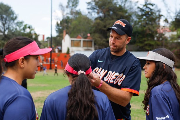 Jason Adam of the San Diego Padres signs autographs for young players during the teamxe2x80x99s kids clinic at Liga Infantil de Beisbol Olmeca A.C on Friday, April 24, 2026 in Mexico City, . (Meg McLaughlin / The San Diego Union-Tribune)
