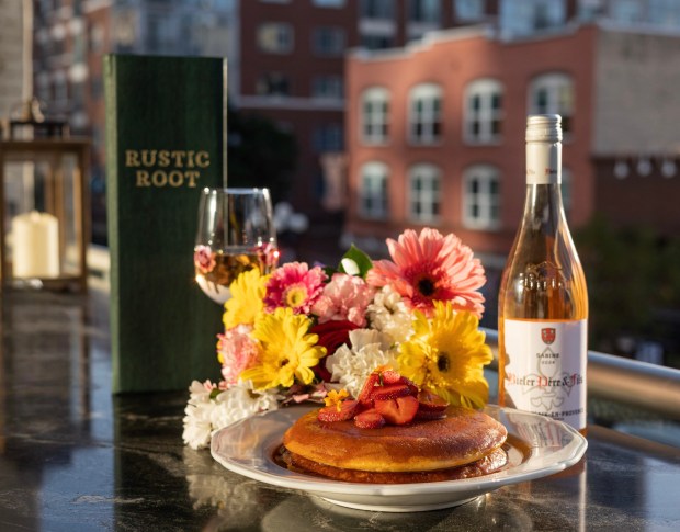 Rustic Root's $19 strawberry cloud pancakes come with macerated strawberries, strawberry-honey glaze and marigolds. (RMD Group)