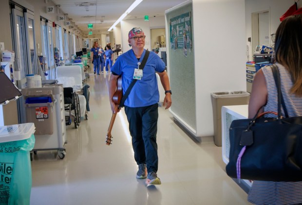 Nurse Rod Salaysay pwalks to patient rooms to play his Ukulele at UCSD Jacobs Medical Center in La Jolla on Wednesday, April 22, 2026. Salaysay has been singing to his patients for over Two decades and plans to retire later this year. (Sandy Huffaker / For The San Diego Union-Tribune)
