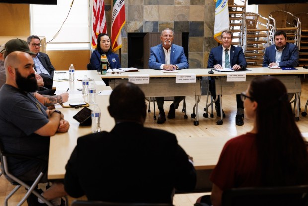 A roundtable meeting on the Tijuana River sewage with Imperial Beach business owners and U.S. Small Business Administration officials at Imperial Beach on Tuesday, March 31, 2026. Imperial Beach Mayor Mitch McKay, center, and U.S. Small Business Administration Deputy Administrator William Briggs, right, listen during the meeting. (Kristian Carreon / The San Diego Union-Tribune)
