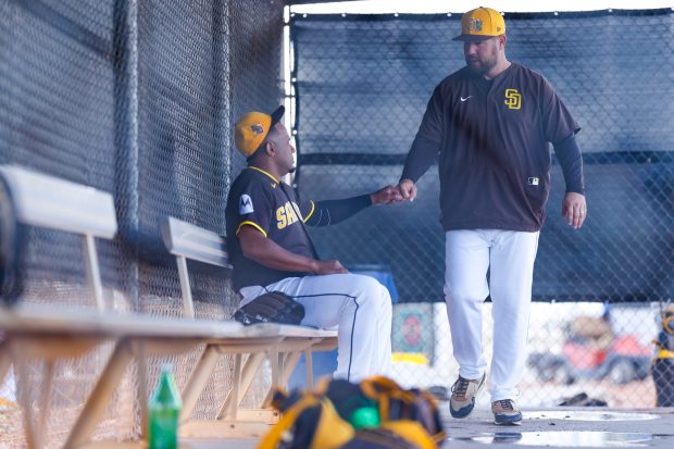 Wandy Peralta of the San Diego Padres greets Ben Fritz during spring training workouts at the Peoria Sports Complex on Tuesday, Feb. 17, 2026 in Peoria, Ariz.(Meg McLaughlin / The San Diego Union-Tribune)
