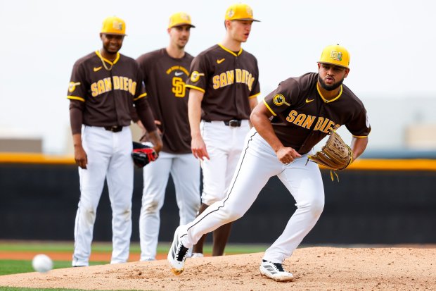 Randy Vasquez #98 of the San Diego Padres, center, participates in drills during the first day of spring training workouts at the Peoria Sports Complex on Wednesday, Feb. 11, 2026 in Peoria, Ariz.(Meg McLaughlin / The San Diego Union-Tribune)