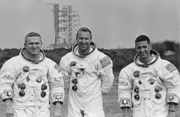 Apollo 8 astronauts Frank Borman, James A. Lovell Jr., and William A. Anders (l to r) pose in front of the Saturn V rocket in Cape Kennedy, Florida, Oct. 22, 1968. (AP Photo)