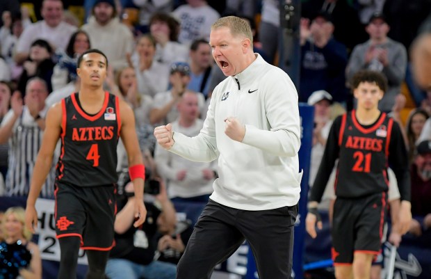 Utah State head coach Jerrod Calhoun celebrates in the home win against SDSU on Jan. 31.