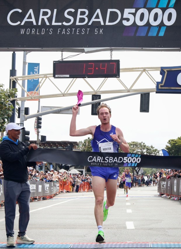 Drew Hunter crosses the finish line during the Men's Elite catagory during the Carlsbad 5000 on Sunday, April 12, 2026. The race is celebrating it's 40th year and is one of the county's most popular. (Photo by Sandy Huffaker for The San Diego Union-Tribune)