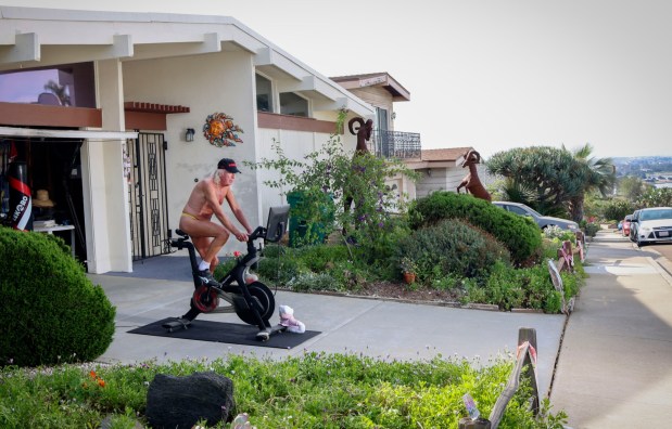 Danny Smiechowski exercises in front of his home in Bay Ho on Friday, April 3, 2026. Smiechowski is on the most recent episode of the new HBO series Neighbors and has been conflict between his neighbors over him working out on his driveway wearing almost no clothing. (Sandy Huffaker for The San Diego Union-Tribune)