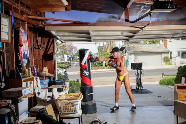 Danny Smiechowski exercises in front of his home in Bay Ho on Friday, April 3, 2026. Smiechowski is on the most recent episode of the new HBO series Neighbors and has been conflict between his neighbors over him working out on his driveway wearing almost no clothing.