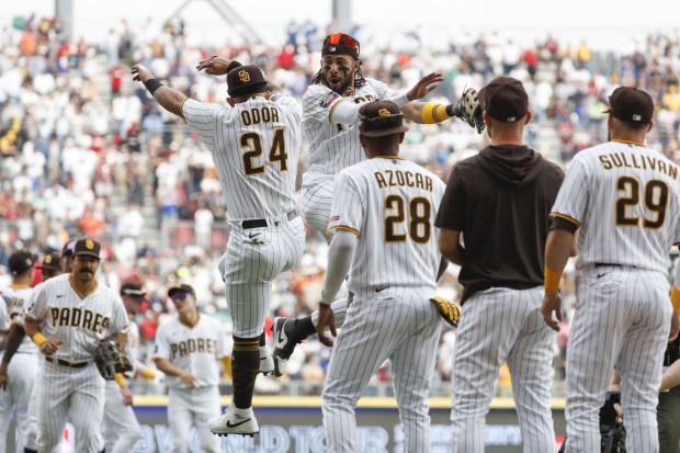 Padres right fielder Rougned Odor (24) and right fielder Fernando Tatis Jr. (23) celebrate beating the Giants during the second Mexico City Series game at Estadio Alfredo Harp Helu on Sunday, April 30, 2023 in Mexico City. (Meg McLaughlin / The San Diego Union-Tribune)