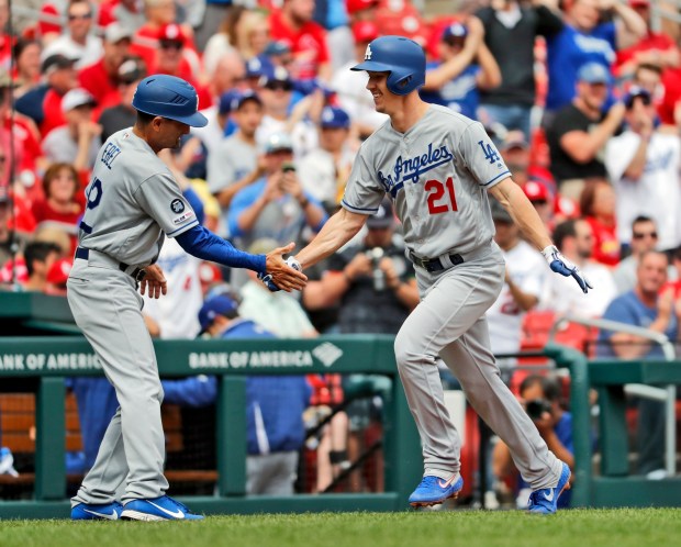 Los Angeles Dodgers' Walker Buehler (21) is congratulated by third base coach Dino Ebel after hitting a solo home run during the second inning of a baseball game against the St. Louis Cardinals Thursday, April 11, 2019, in St. Louis. (AP Photo/Jeff Roberson)