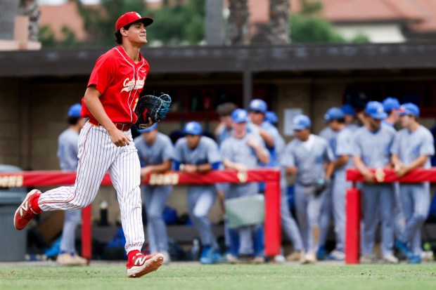 Cathedral Catholic's Max Stewart #28 smiles as he runs back to the dugout during the 75th Lions Tournament title game against Rancho Bernardo at Mt. Carmel High School on Thursday, April 2, 2026 in San Diego, California. (Meg McLaughlin / The San Diego Union-Tribune)