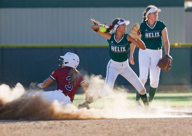 Helix's Clarissa Torres #22 tags out Steele Canyon's Ily Barclay #3 and attempts to turn a double play during their game at Helix High School on Wednesday, April 8, 2026 in La Mesa, California. (Meg McLaughlin / The San Diego Union-Tribune)