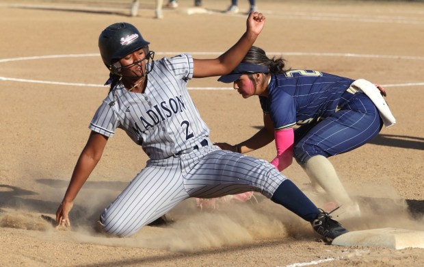 Madison's Aryana Burnett slides safe into third base as Morse's Thaliamia Richards tries to tag in the seventh inning at Morse High School in San Diego on Thursday, April 16, 2026. (Hayne Palmour IV / For The San Diego Union-Tribune)