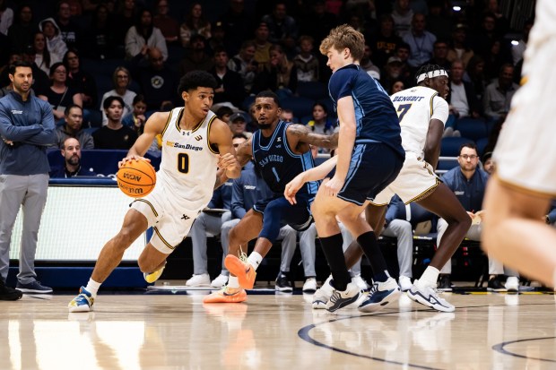 UC San Diego's Hudson Mayes drives to the basket during a Dec. 19 game against USD at LionTree Arena. (Derrick Tuskan, UC San Diego athletics)