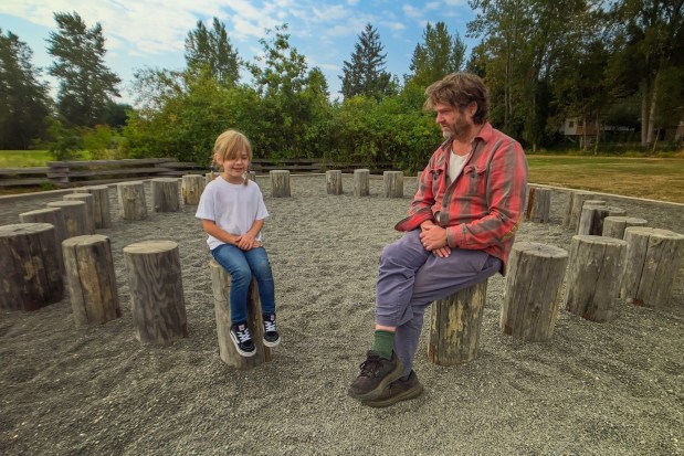 Zach Galifianakis, right, interviews a child about root vegetables in a scene from his gardening TV series, "This Is a Gardening Show." (Netflix via AP)