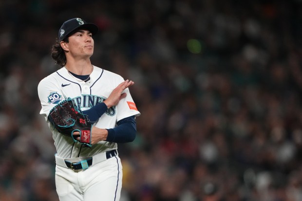 Seattle Mariners starting pitcher Bryan Woo reacts to the third out of the top of the fifth inning of a baseball game against the Cleveland Guardians, Saturday, March 28, 2026, in Seattle. (AP Photo/Lindsey Wasson)