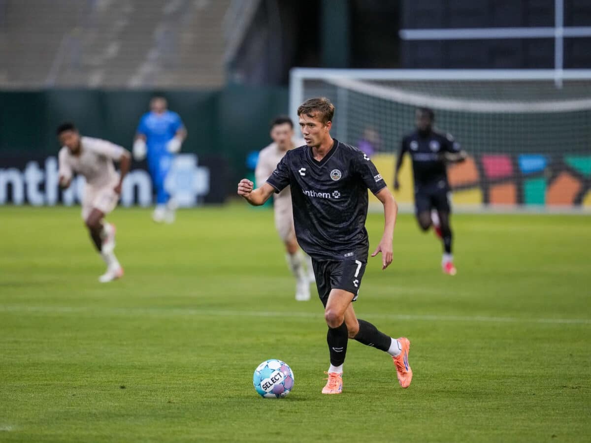 Alameda Post - An Oakland Roots player dribbles the ball in a match against FC Tulsa.