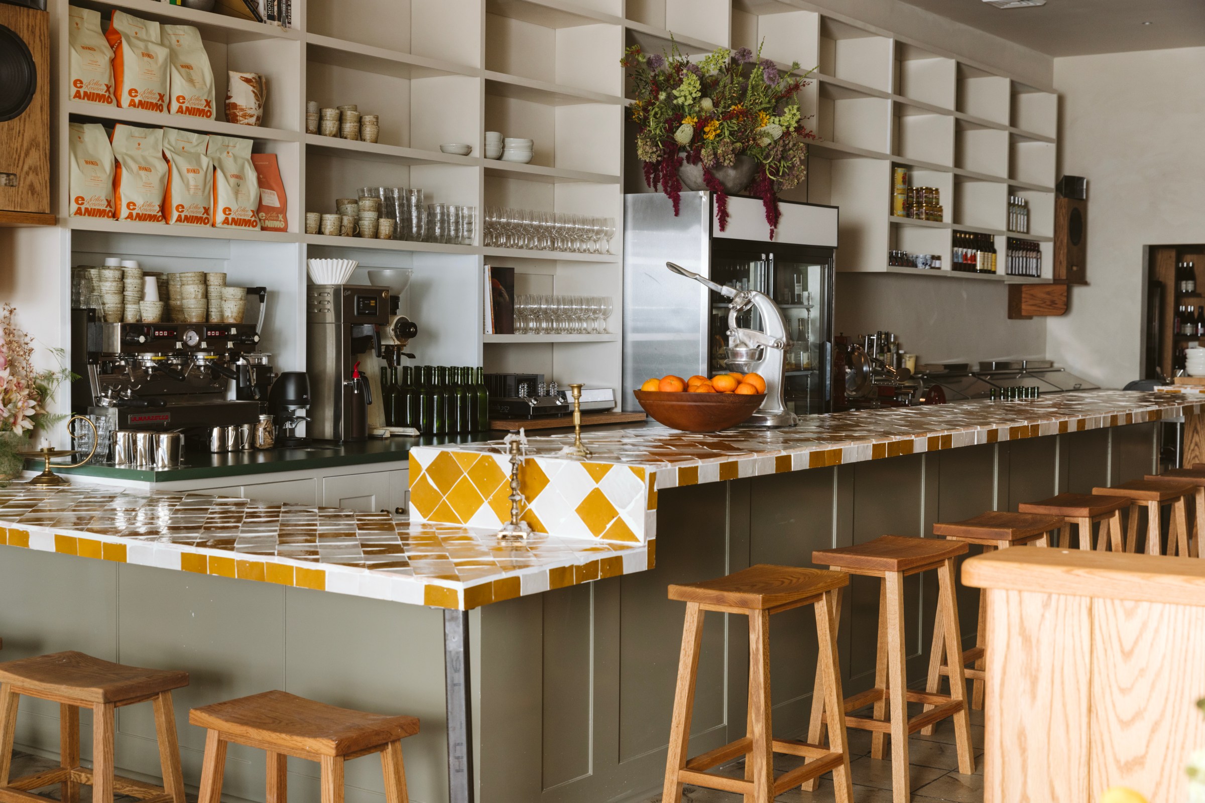 Tiled bar/coffee counter in a sunny tangerine-white pattern.
