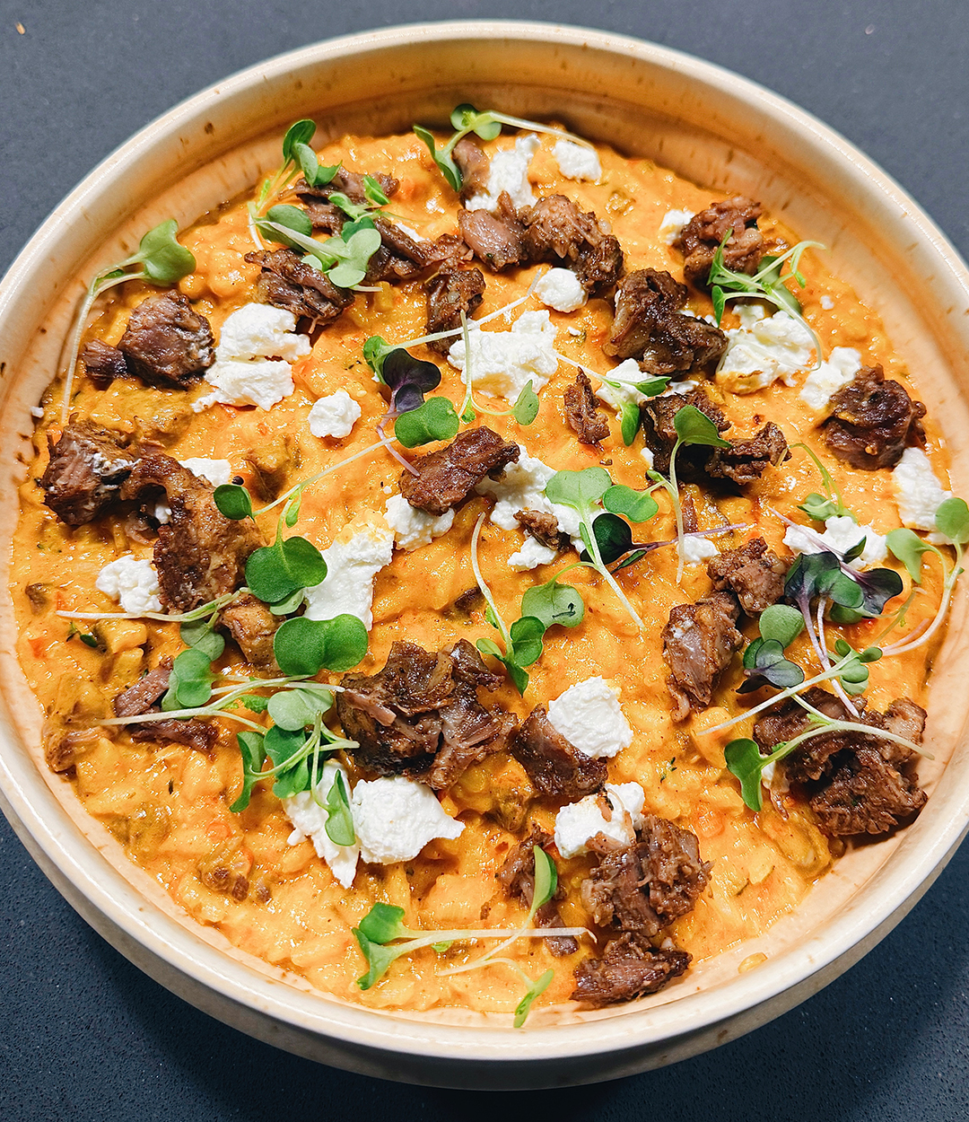 Goat cheese jollof risotto with braised oxtail at Ebi-Ayo Supper Club.
