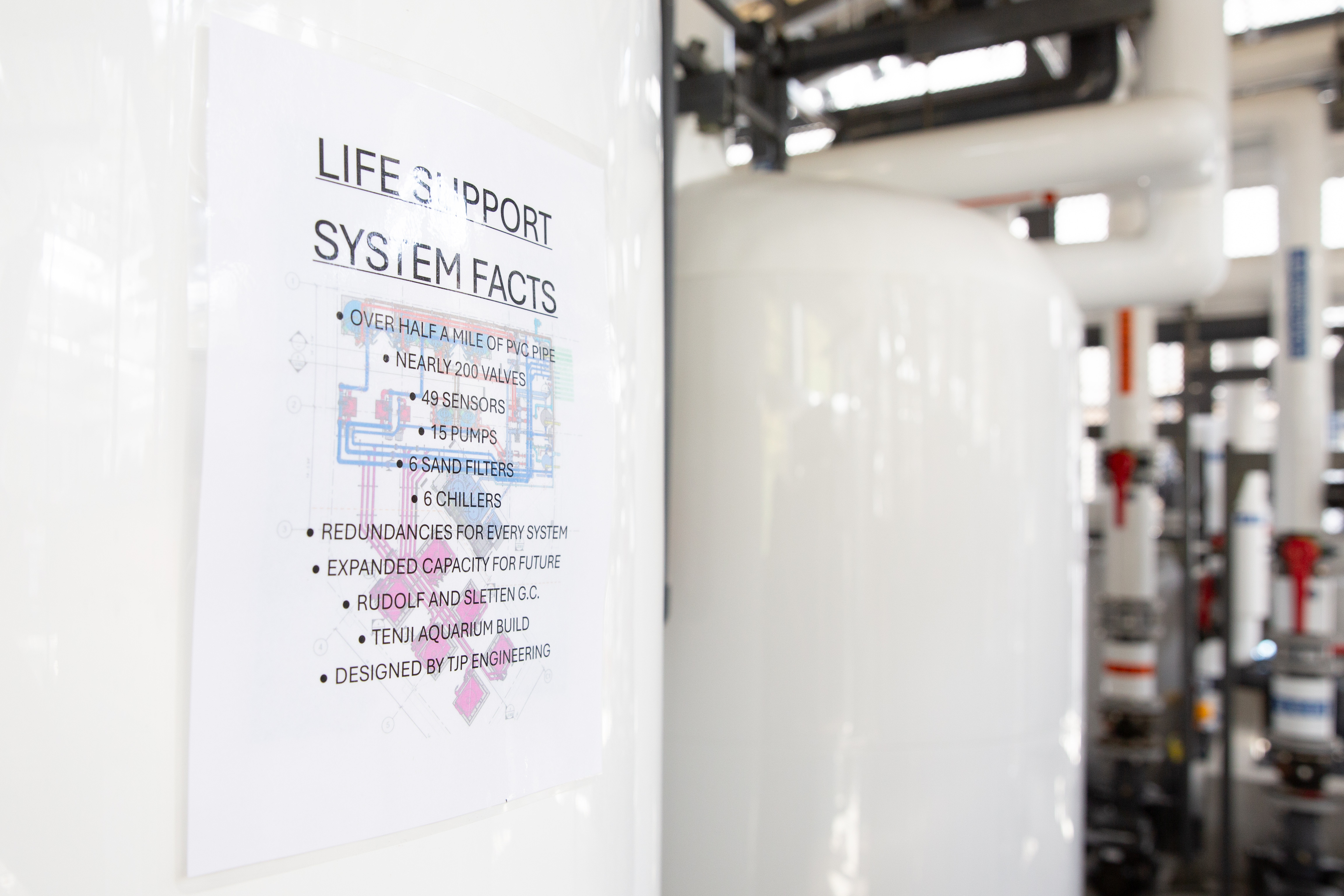 A fact sheet sits attached to a tank, part of...