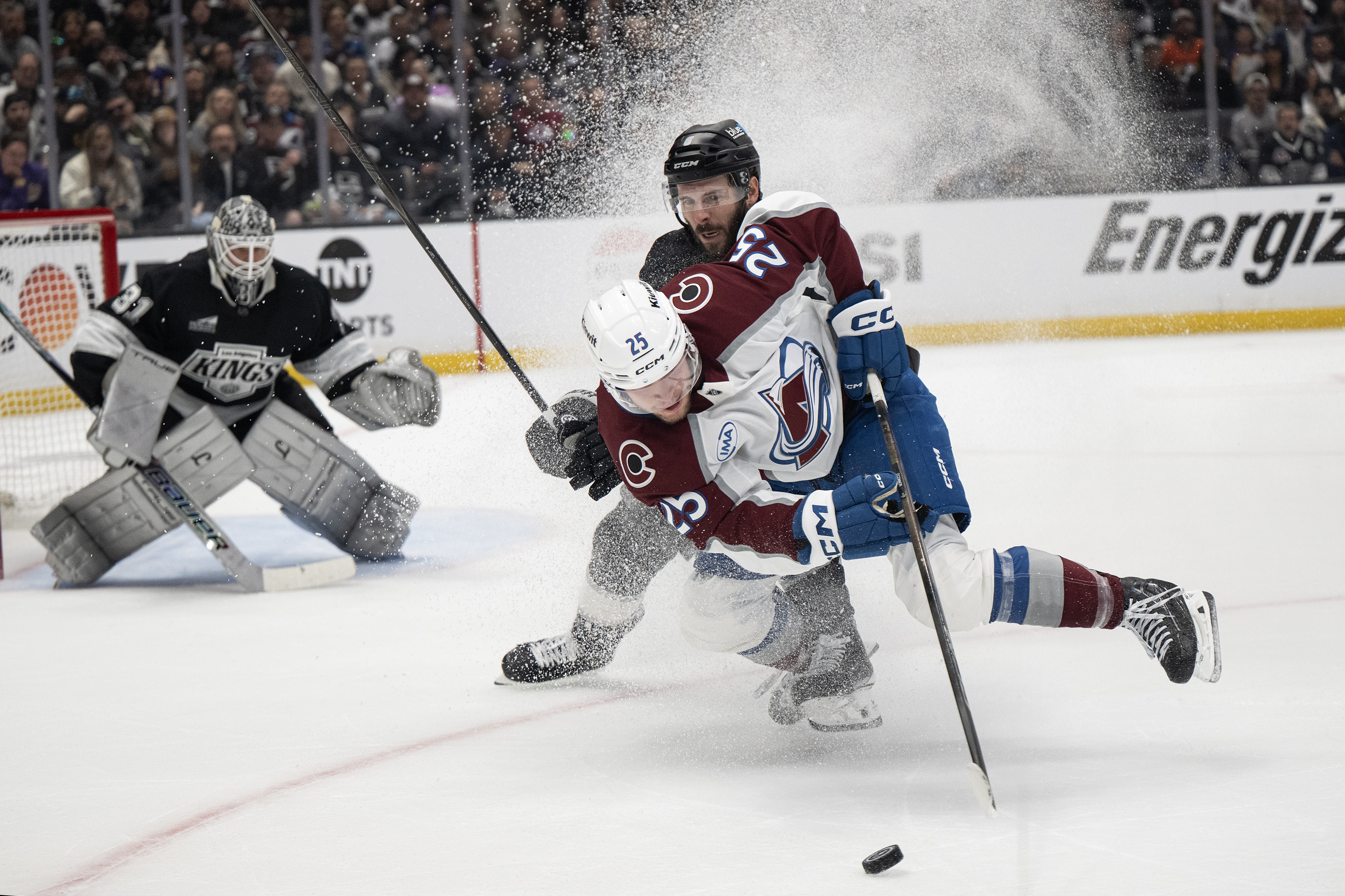Defenseman Joel Edmundson (6) of the Los Angeles Kings trips...