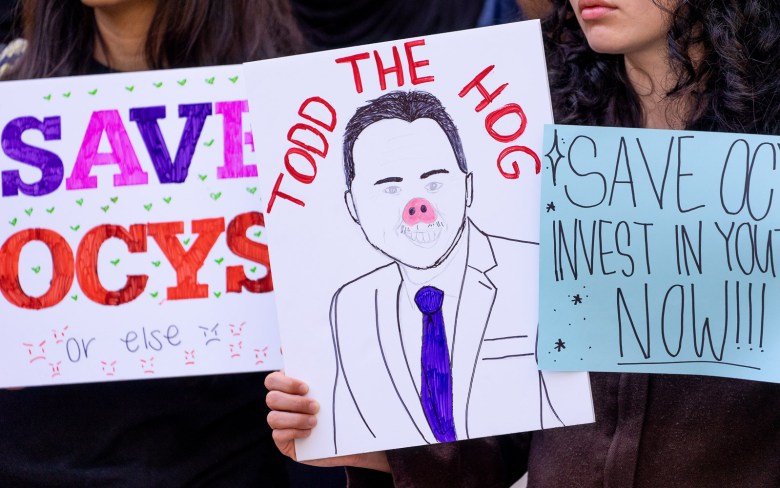 A "Todd the Hog" sign showing Mayor Todd Gloria with a pig nose as part of a raucous crowd turning out to oppose city budget cuts affecting the arts. (Photo by Thomas Murphy/Times of San Diego)