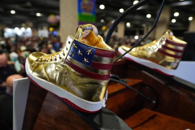 Gold Trump sneakers sit on the podium after Donald Trump spoke.